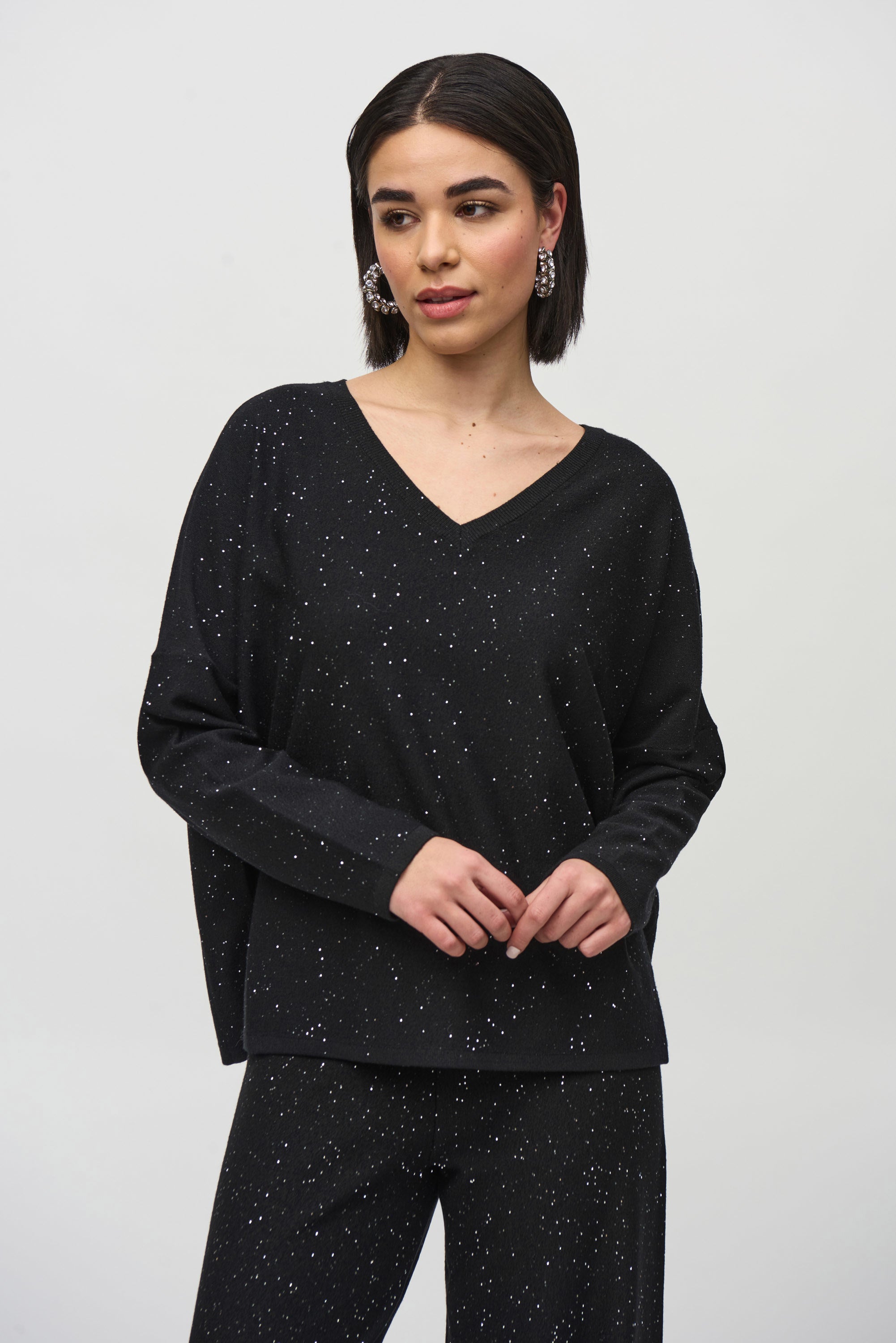 Joseph Ribkoff black Sequined Sweater Knit Boxy Top from the front, back, and side, highlighting the relaxed boxy fit, V-neckline, dolman sleeves, and the fine sequin-embroidered sweater knit texture that adds a subtle allover shimmer.