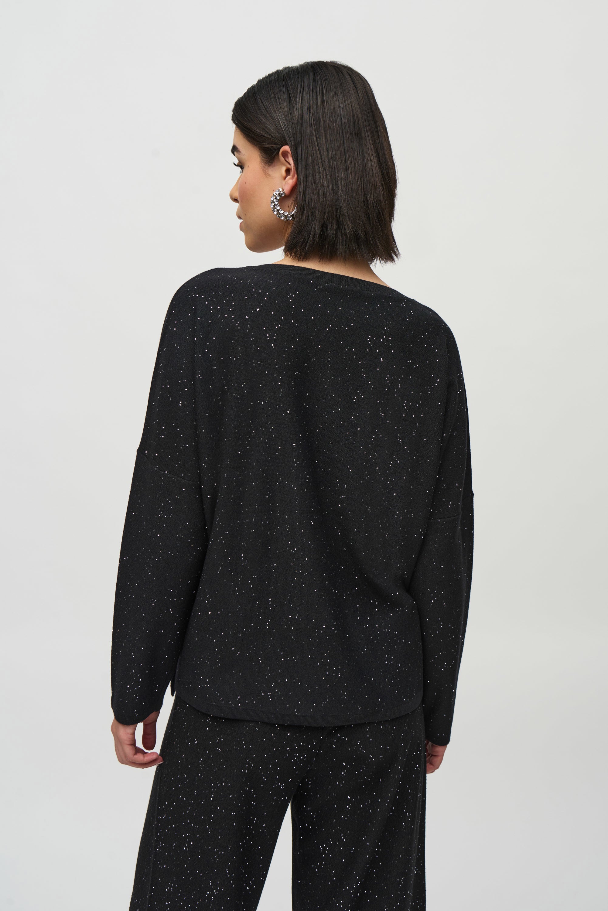 Joseph Ribkoff black Sequined Sweater Knit Boxy Top from the front, back, and side, highlighting the relaxed boxy fit, V-neckline, dolman sleeves, and the fine sequin-embroidered sweater knit texture that adds a subtle allover shimmer.