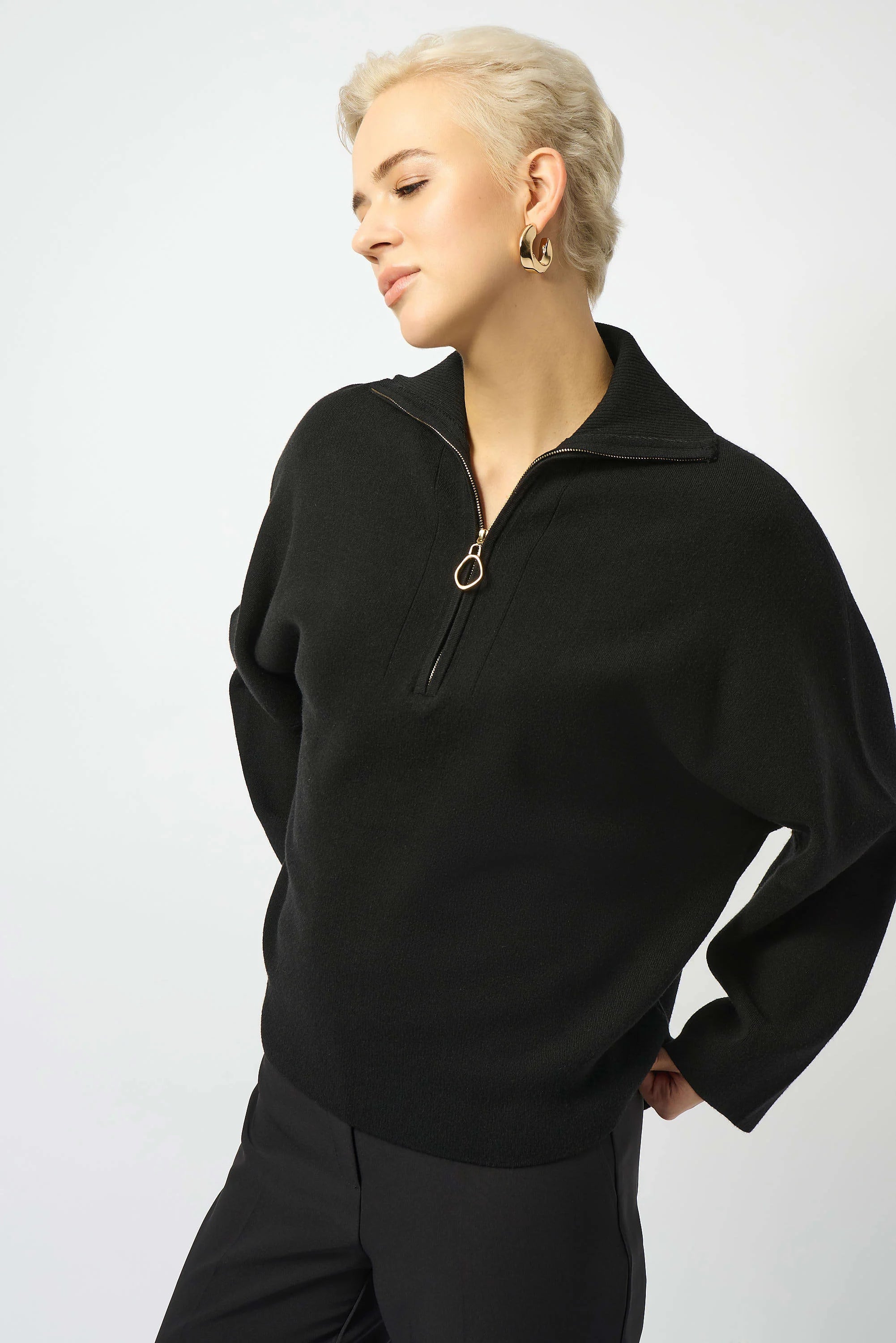 Showcasing the Sweater Knit Boxy Pullover with Zipped Collar by Joseph Ribkoff. Highlights include the relaxed boxy silhouette, functional zip collar, bell sleeves. Available colors Black, Winter White, Avocado, and Medallion, emphasizing fabric texture and fit.