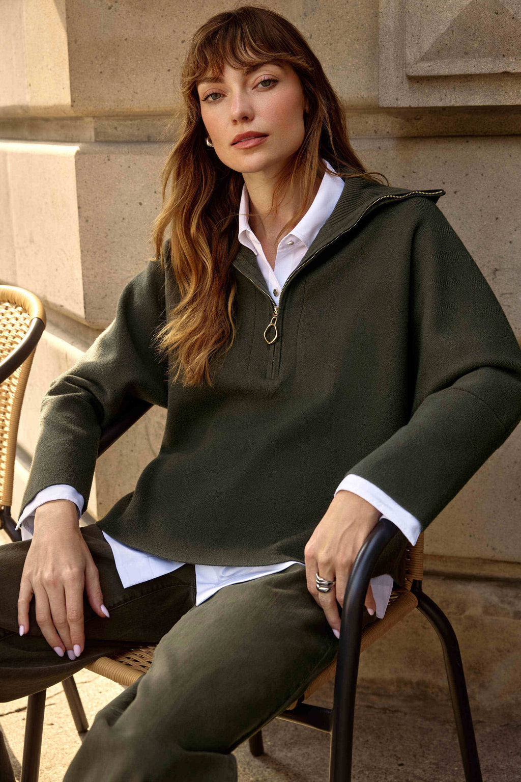 Showcasing the Sweater Knit Boxy Pullover with Zipped Collar by Joseph Ribkoff. Highlights include the relaxed boxy silhouette, functional zip collar, bell sleeves. Available colors Black, Winter White, Avocado, and Medallion, emphasizing fabric texture and fit.