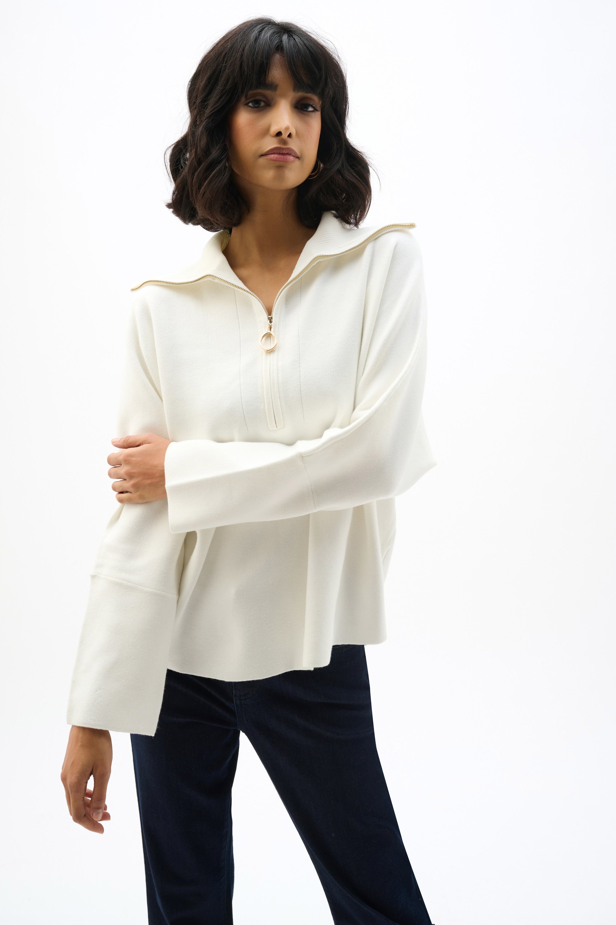 Showcasing the Sweater Knit Boxy Pullover with Zipped Collar by Joseph Ribkoff. Highlights include the relaxed boxy silhouette, functional zip collar, bell sleeves. Available colors Black, Winter White, Avocado, and Medallion, emphasizing fabric texture and fit.