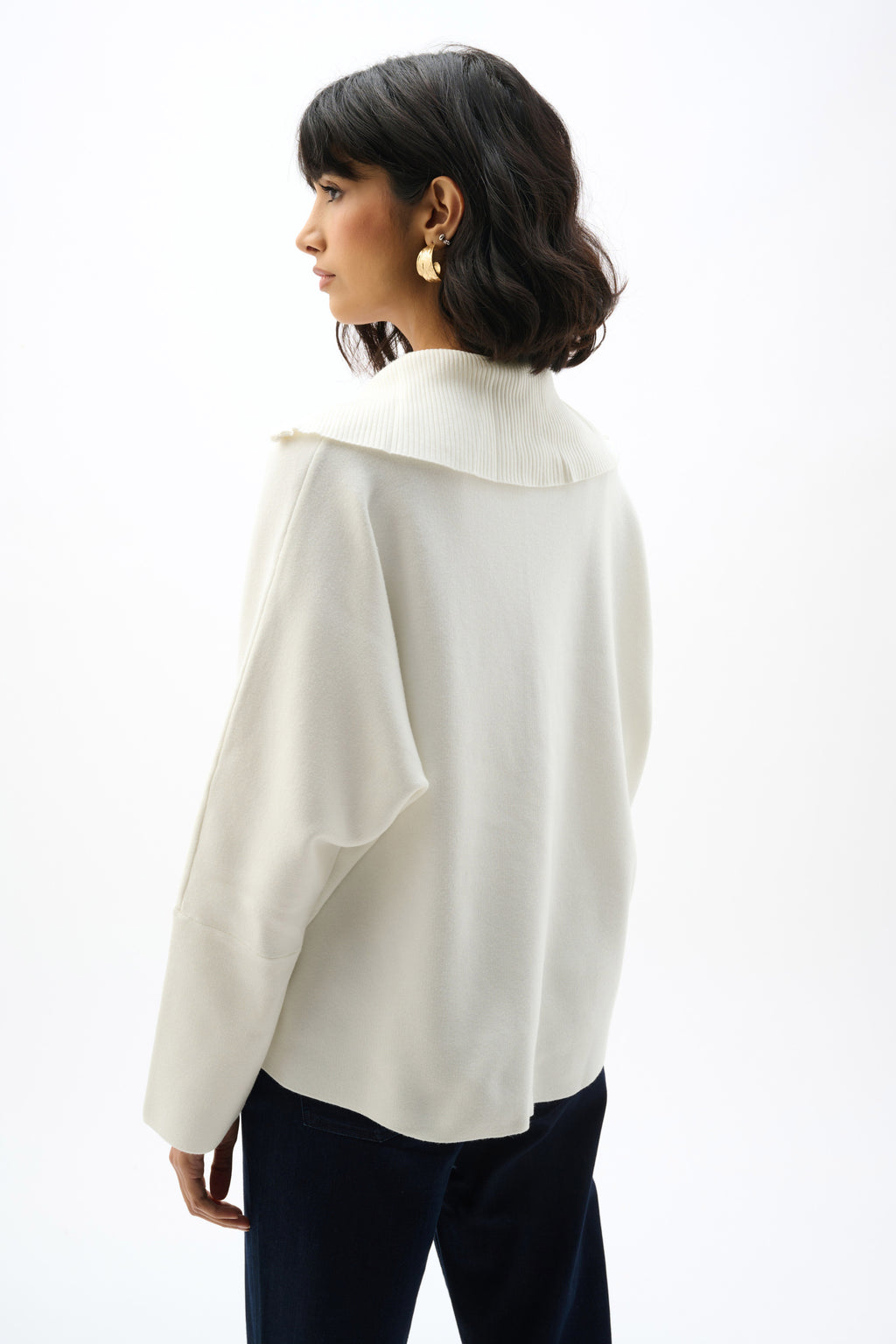 Showcasing the Sweater Knit Boxy Pullover with Zipped Collar by Joseph Ribkoff. Highlights include the relaxed boxy silhouette, functional zip collar, bell sleeves. Available colors Black, Winter White, Avocado, and Medallion, emphasizing fabric texture and fit.