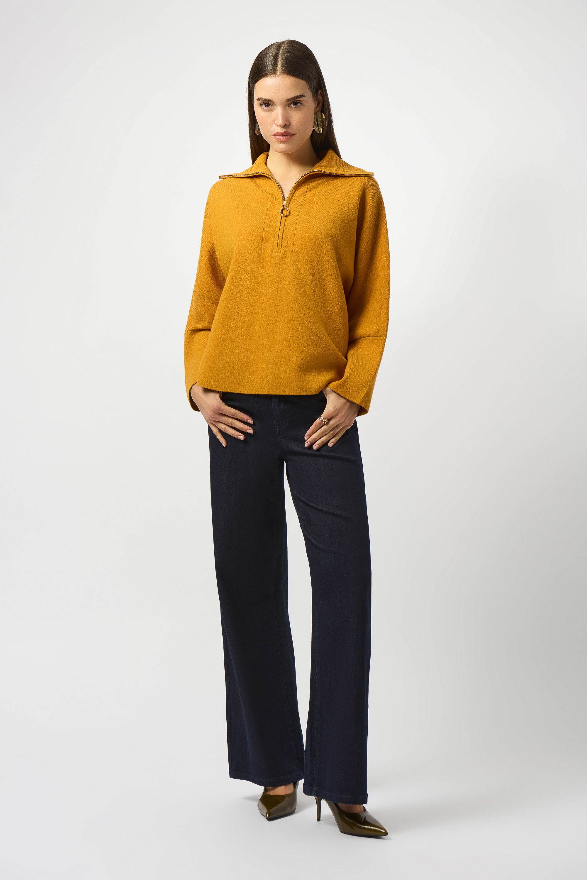 Showcasing the Sweater Knit Boxy Pullover with Zipped Collar by Joseph Ribkoff. Highlights include the relaxed boxy silhouette, functional zip collar, bell sleeves. Available colors Black, Winter White, Avocado, and Medallion, emphasizing fabric texture and fit.