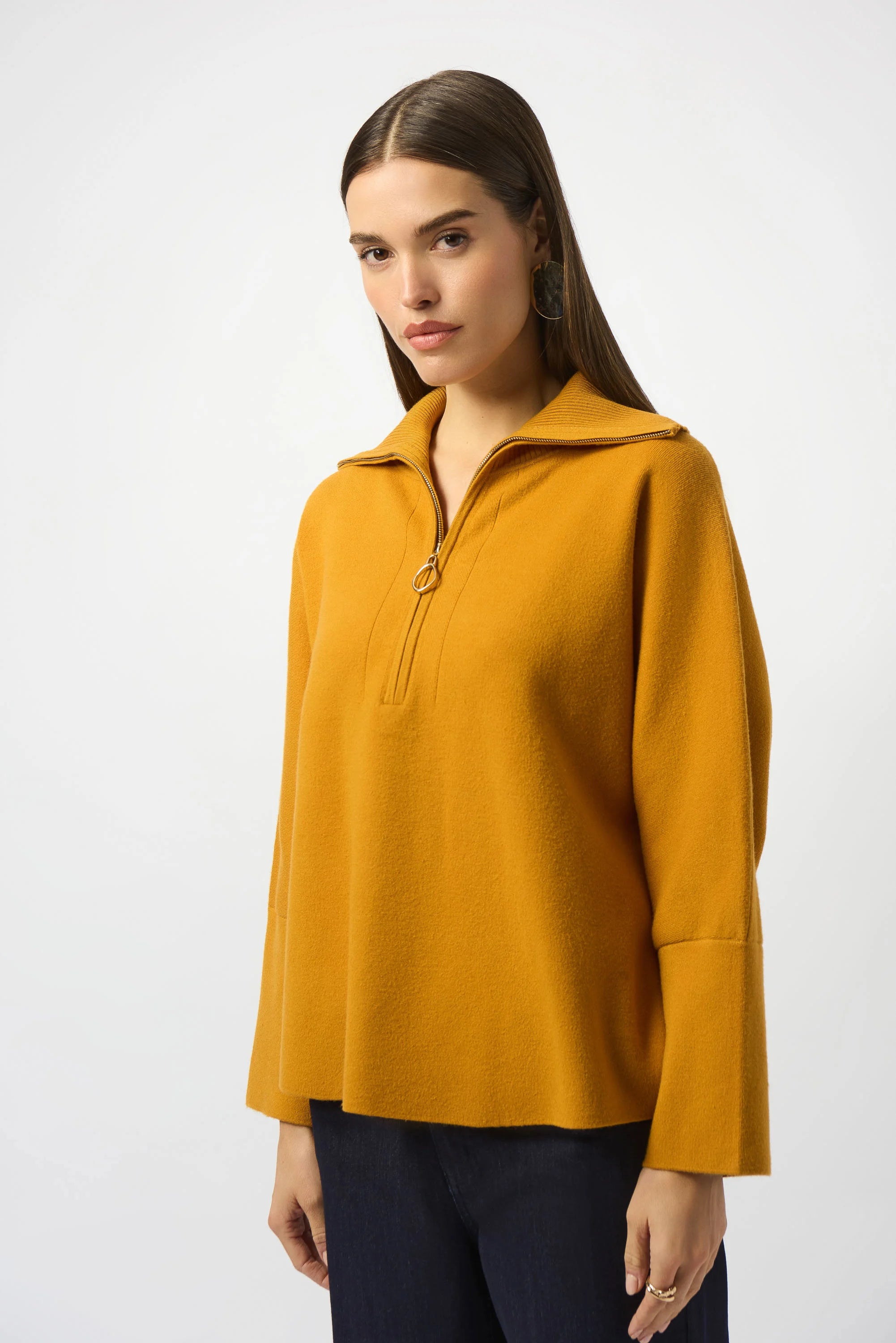 Showcasing the Sweater Knit Boxy Pullover with Zipped Collar by Joseph Ribkoff. Highlights include the relaxed boxy silhouette, functional zip collar, bell sleeves. Available colors Black, Winter White, Avocado, and Medallion, emphasizing fabric texture and fit.