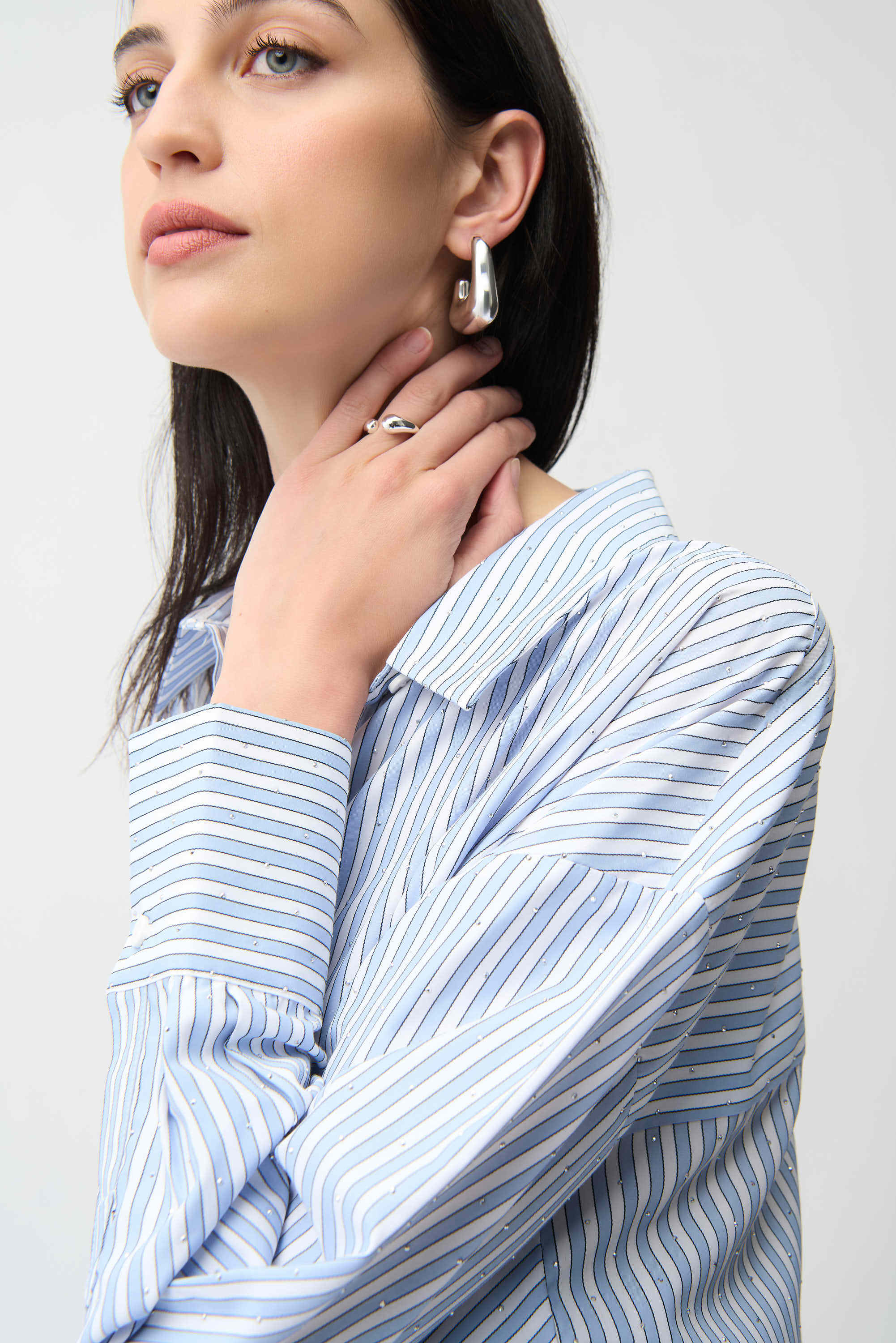 Clear product images showcasing the Tencel Stripe Print Boxy Blouse by Joseph Ribkoff. Highlighting the relaxed boxy fit, vertical stripe pattern, classic collar, and buttoned long sleeves. Visual details emphasize the soft fabric texture and stylish versatility suitable for various occasions.