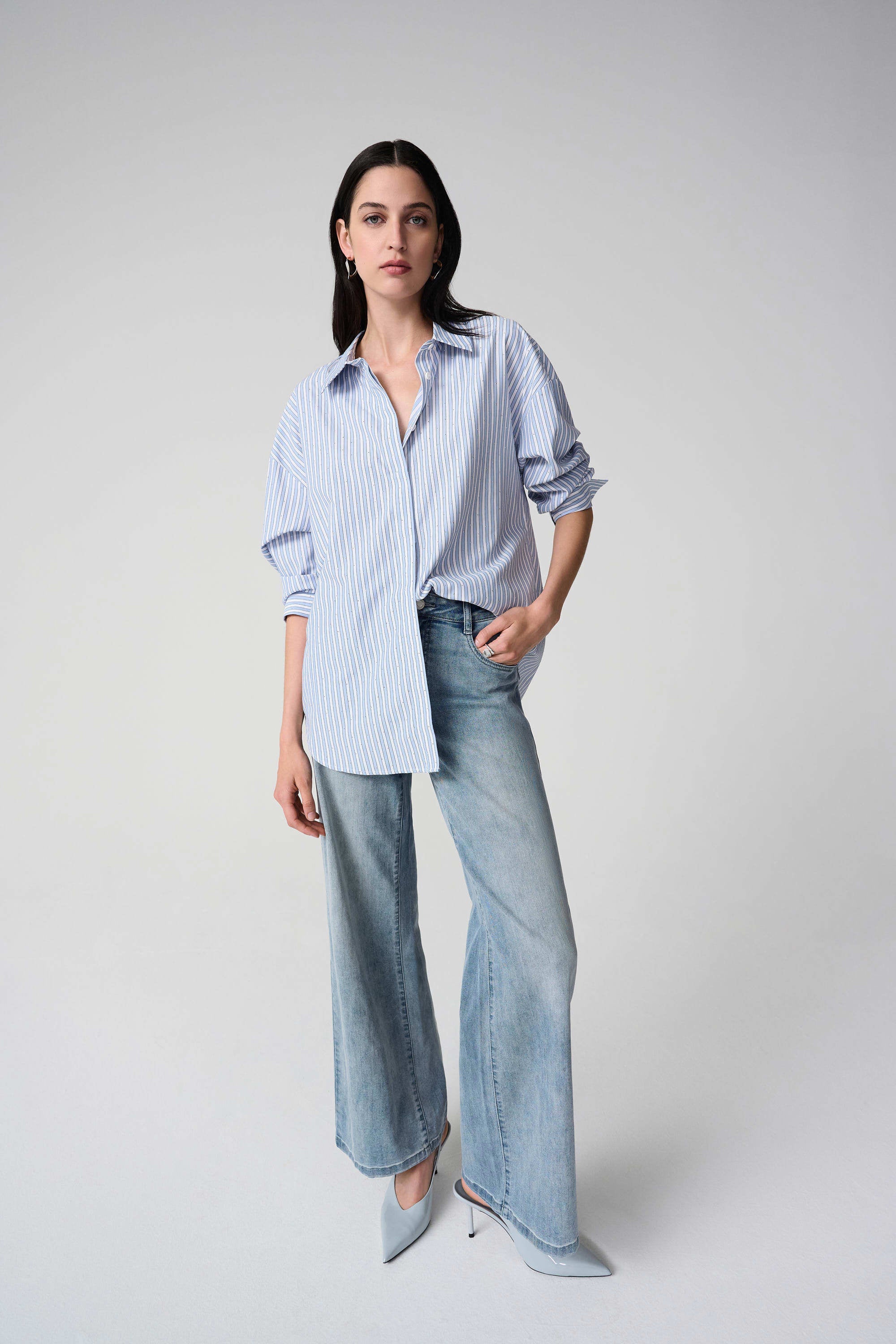 Clear product images showcasing the Tencel Stripe Print Boxy Blouse by Joseph Ribkoff. Highlighting the relaxed boxy fit, vertical stripe pattern, classic collar, and buttoned long sleeves. Visual details emphasize the soft fabric texture and stylish versatility suitable for various occasions.