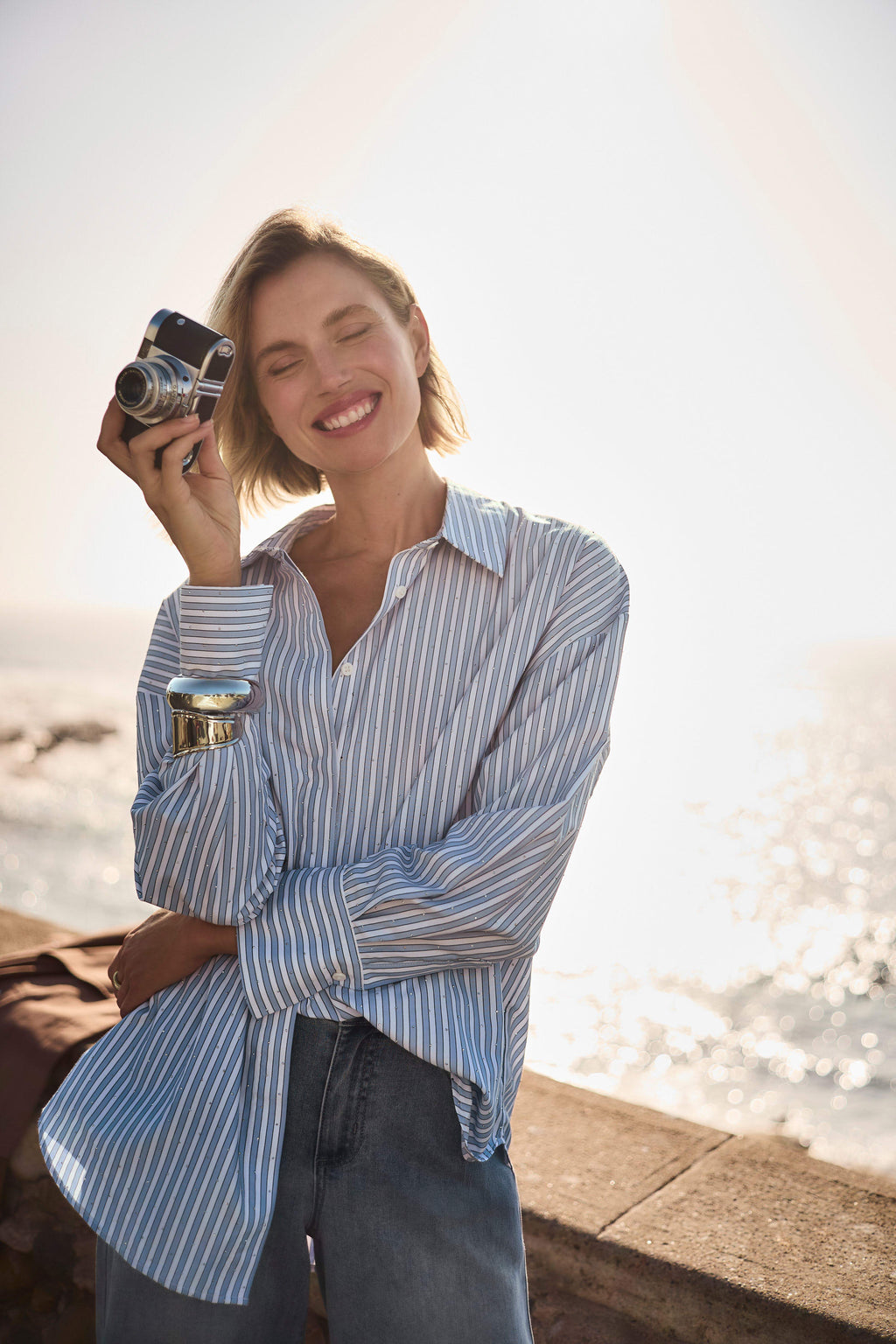 Clear product images showcasing the Tencel Stripe Print Boxy Blouse by Joseph Ribkoff. Highlighting the relaxed boxy fit, vertical stripe pattern, classic collar, and buttoned long sleeves. Visual details emphasize the soft fabric texture and stylish versatility suitable for various occasions.