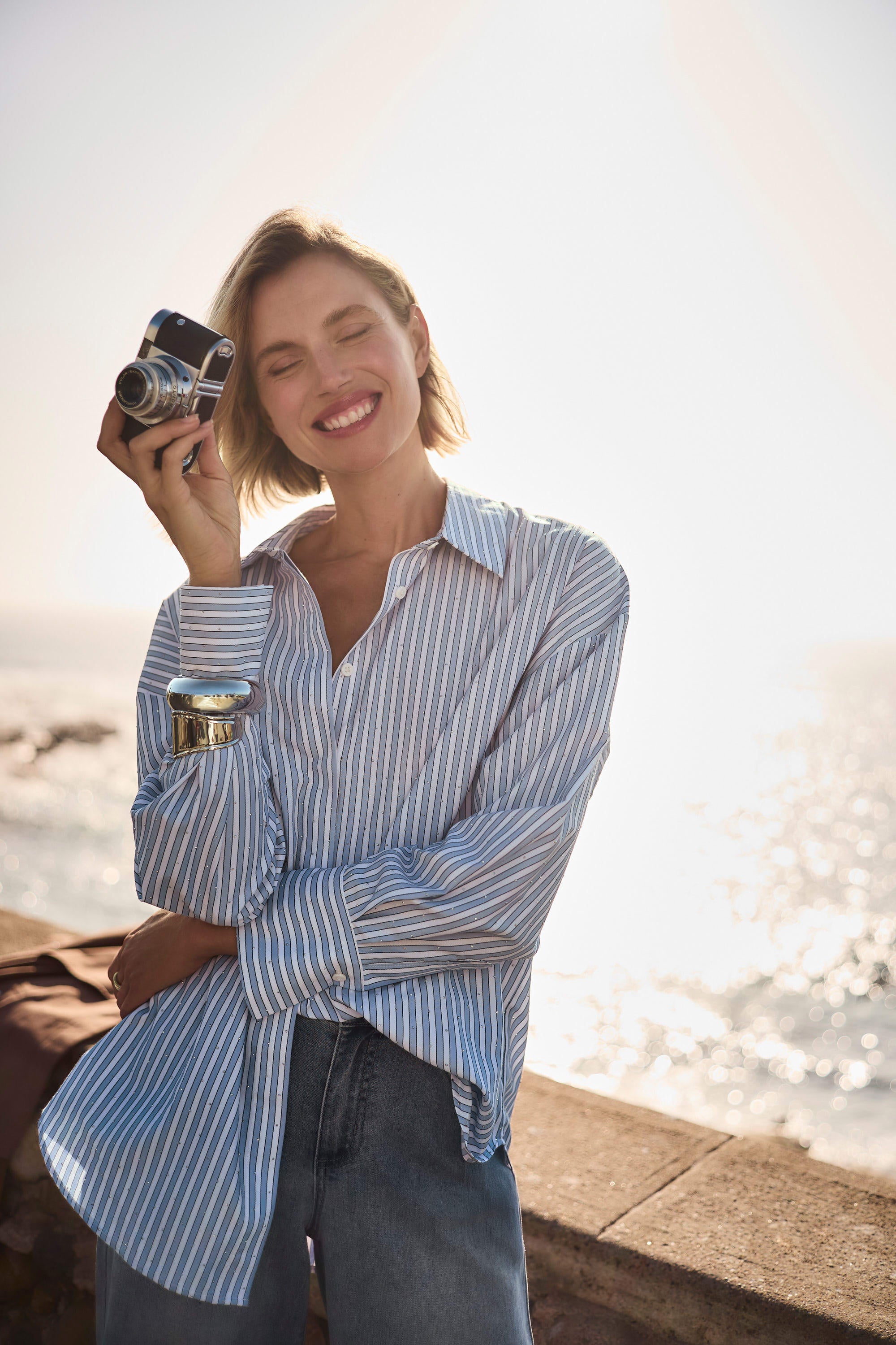 Clear product images showcasing the Tencel Stripe Print Boxy Blouse by Joseph Ribkoff. Highlighting the relaxed boxy fit, vertical stripe pattern, classic collar, and buttoned long sleeves. Visual details emphasize the soft fabric texture and stylish versatility suitable for various occasions.