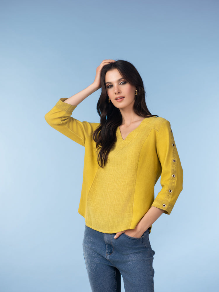 High-quality images showcase the Brenda Eyelet-Sleeve Linen Blend Top in amber, coral, and white, highlighting the breathable woven texture, V-neckline, eyelet button sleeve details, and relaxed A-line fit.