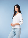 High-quality images showcase the Brenda Eyelet-Sleeve Linen Blend Top in amber, coral, and white, highlighting the breathable woven texture, V-neckline, eyelet button sleeve details, and relaxed A-line fit.