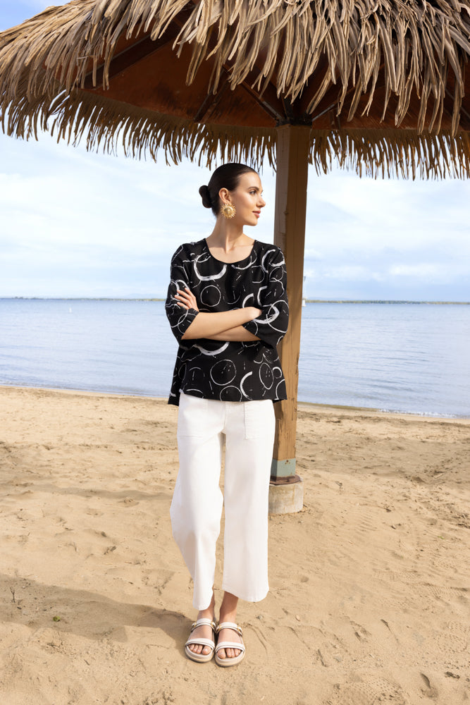 Alison Sheri Wide Leg Cropped Pants A47587 in white and black from the front and side, highlighting the high-rise pull-on waistband, wide leg shape, cropped hem, and fluid drape of the lightweight fabric.