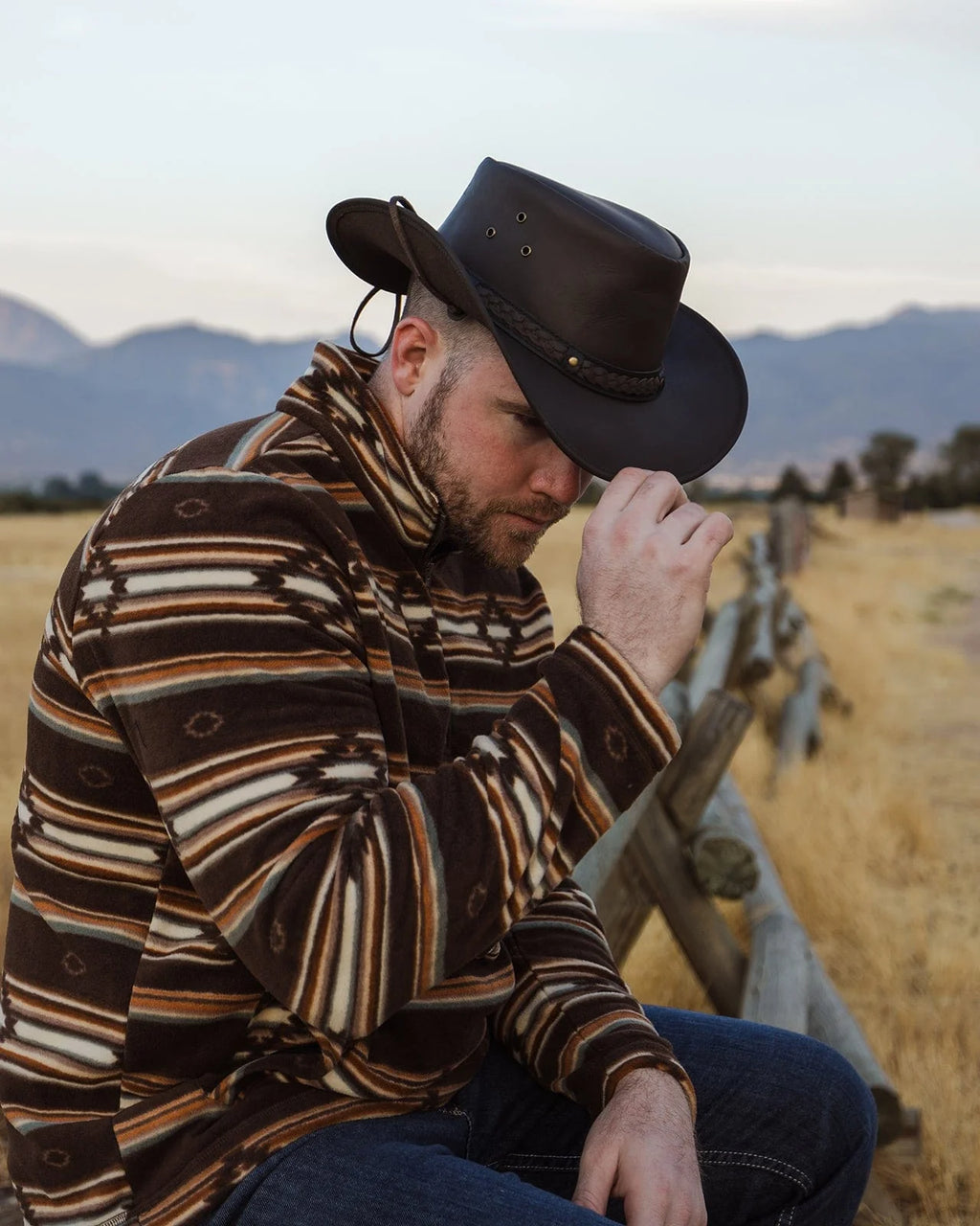 Wagga Wagga Leather Hat in chocolate color, highlighting the smooth leather texture, structured crown, wire brim, chin cord, and comfortable sweatband.