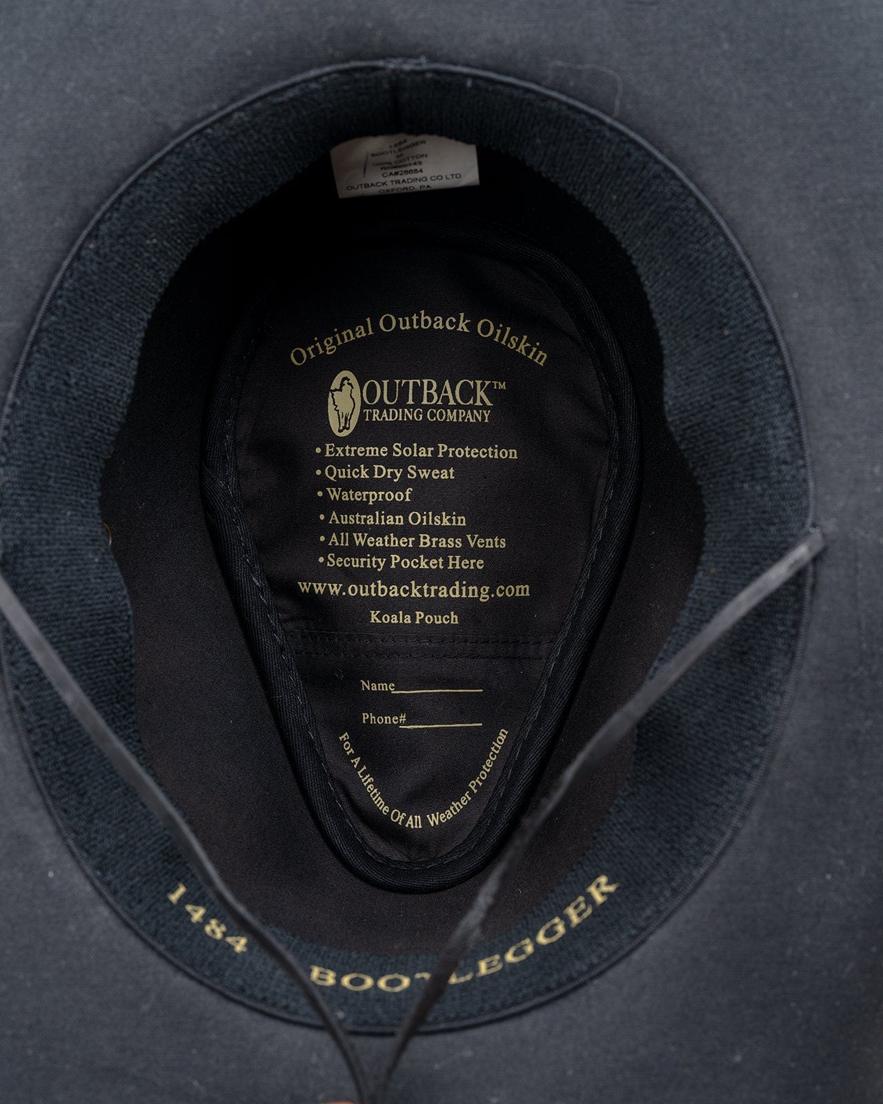 Bootlegger Oilskin Hat in black by Outback Trading Co., showcasing its structured crown, wire brim, chin cord, and moisture-wicking sweatband. Photos include front, side, and rear views highlighting the hat’s rugged material, shape, and functional details.