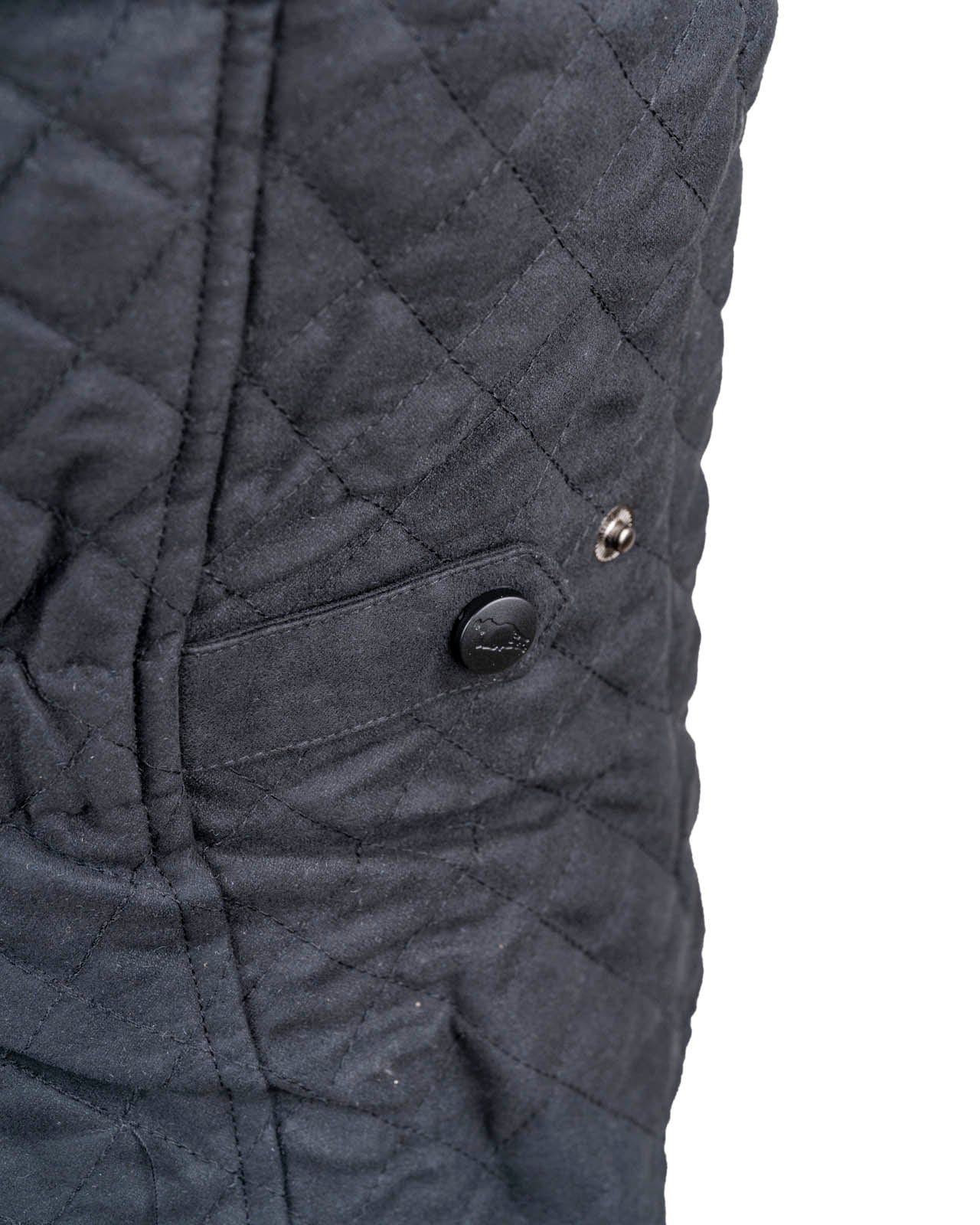 Women’s Grand Prix Vest by Outback Trading Co. in black, highlighting the quilted microsuede fabric, 2-way zipper closure, zippered pockets, adjustable back tabs, and drop-tail hem. Photos provide front, back, and close-up views emphasizing texture, fit, and craftsmanship.