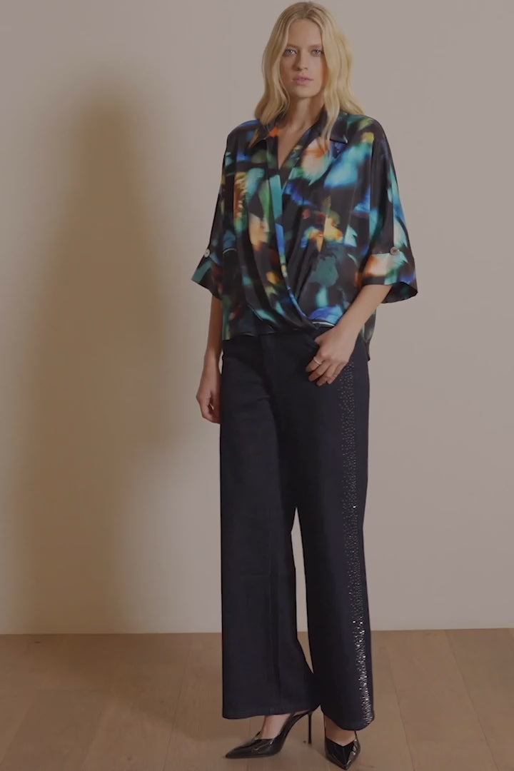 Classic Wide Leg Jeans by Joseph Ribkoff in dark denim blue, highlighting the wide-leg fit, rhinestone detailing along the seams, and classic denim texture. Photos include front, back, and close-up views focusing on sparkling rhinestone accents and fabric quality.