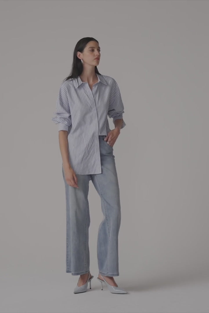 Clear product images showcasing the Tencel Stripe Print Boxy Blouse by Joseph Ribkoff. Highlighting the relaxed boxy fit, vertical stripe pattern, classic collar, and buttoned long sleeves. Visual details emphasize the soft fabric texture and stylish versatility suitable for various occasions.